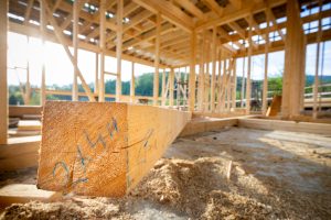 Wooden beam at the construction of a frame house